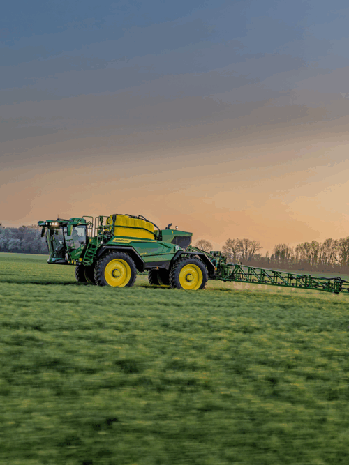 550R Sprayer John Deere in sunset