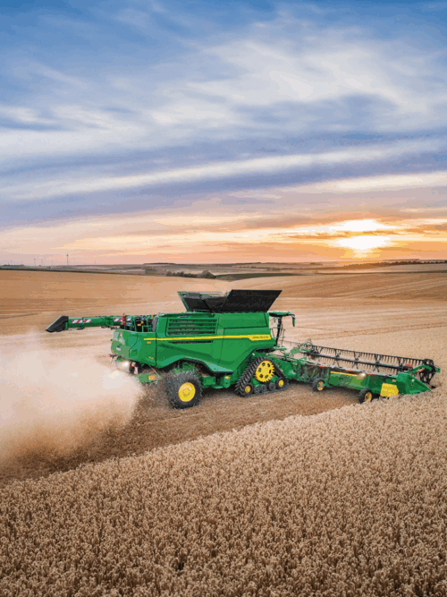 John Deere Combine at sunset